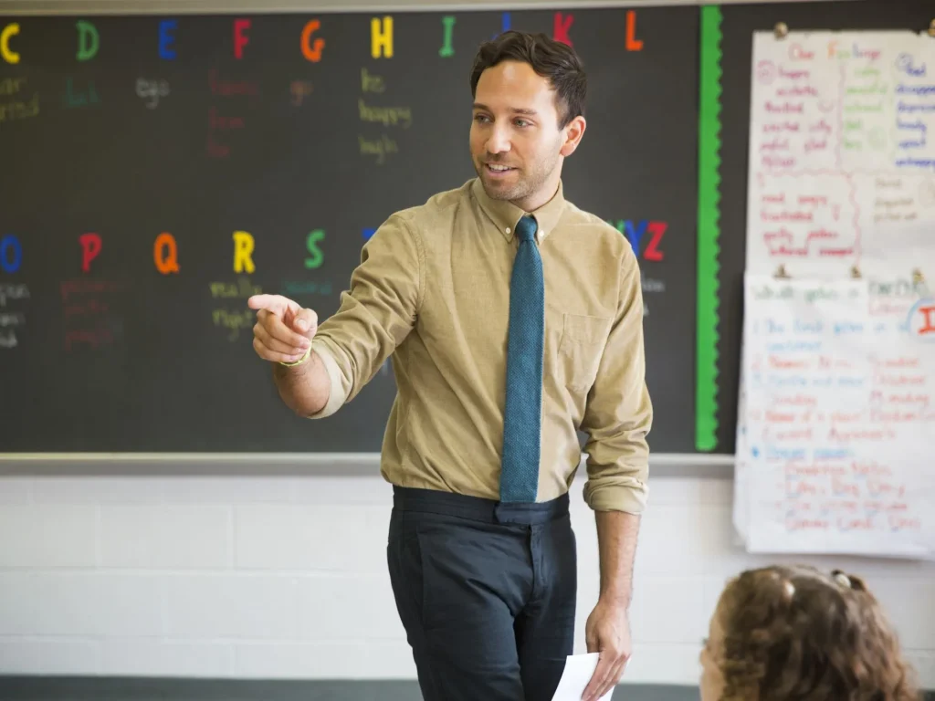 teacher-pointing-while-teaching-in-classroom